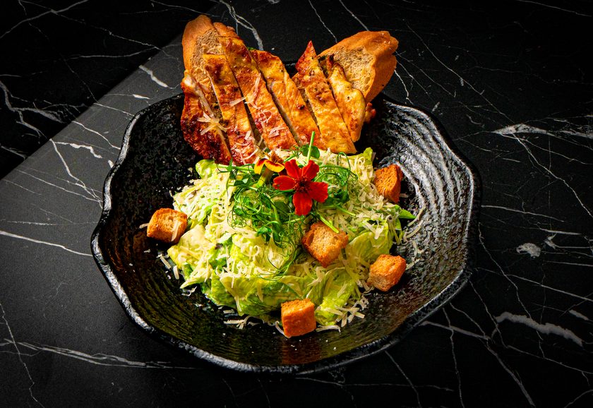 Sliced grilled chicken over romaine with croutons and parmesan