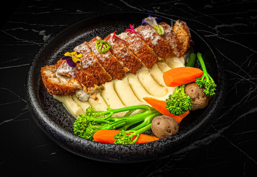 Breaded chicken roll with mashed potato and vegetables