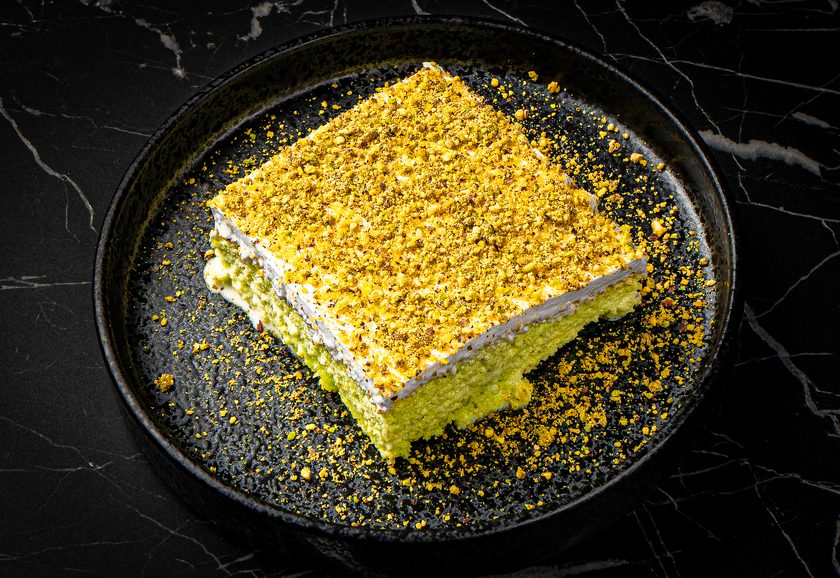 Pistachio milk cake topped with crushed pistachios