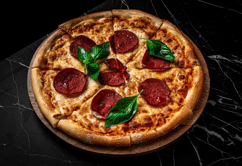 Salami pizza with mozzarella and basil