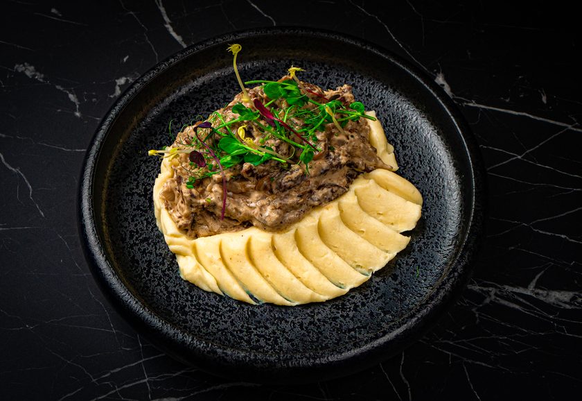 Beef stroganoff in cream sauce with piped mashed potato