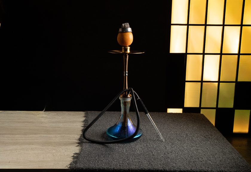 A shisha with a fresh orange as the head